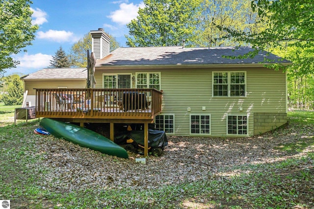 4667 Arbor Latch, Traverse City, MI 49685 - rear view of house featuring a chimney and a wooden deck