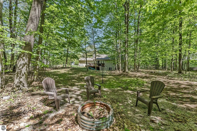 4667 Arbor Latch, Traverse City, MI 49685 - view of grassy yard featuring an outdoor fire pit
