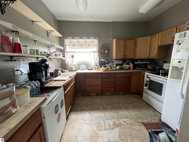 6993 E 34th Rd, Cadillac, MI 49601 - kitchen with white appliances, light countertops, open shelves, and light stone finish floors