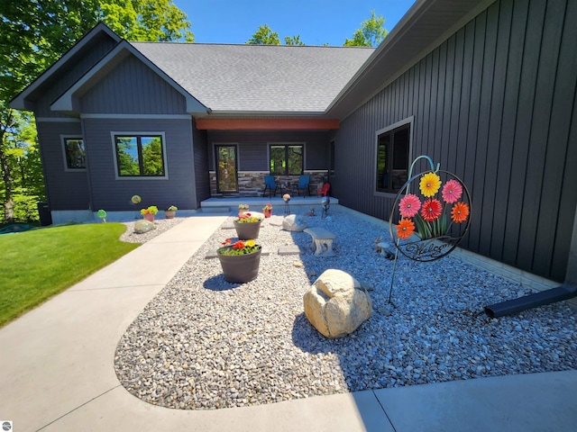 6238 E Gallivan Rd, Cedar, MI 49621 - view of exterior entry with a patio and a lawn