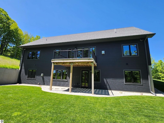 6238 E Gallivan Rd, Cedar, MI 49621 - back of property featuring a balcony, a lawn, and a patio area