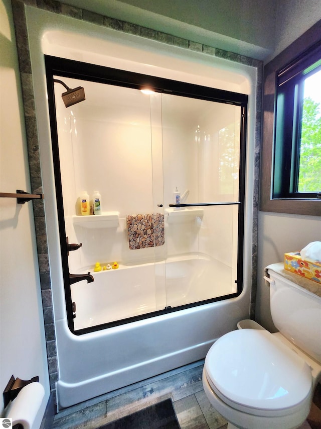 6238 E Gallivan Rd, Cedar, MI 49621 - full bathroom with enclosed tub / shower combo, wood finished floors, and toilet