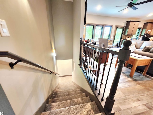 6238 E Gallivan Rd, Cedar, MI 49621 - stairs featuring ceiling fan, wood finished floors, and baseboards