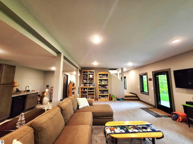6238 E Gallivan Rd, Cedar, MI 49621 - carpeted living room featuring a sink, recessed lighting, built in features, and stairs