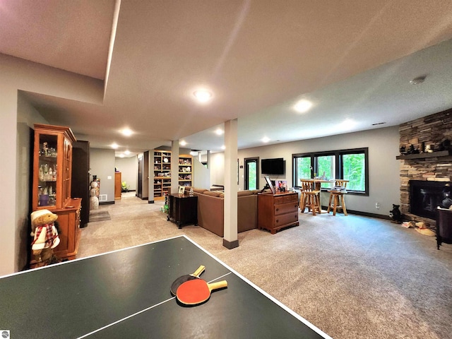6238 E Gallivan Rd, Cedar, MI 49621 - rec room with light carpet, a fireplace, baseboards, and recessed lighting