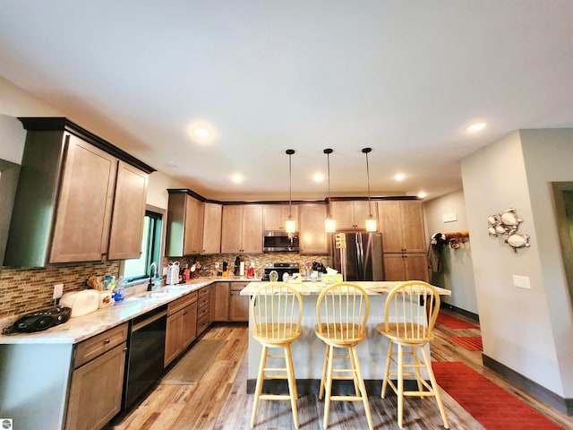 6238 E Gallivan Rd, Cedar, MI 49621 - kitchen with stainless steel appliances, light wood-style floors, a sink, tasteful backsplash, and recessed lighting