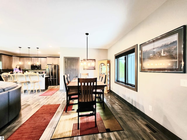 6238 E Gallivan Rd, Cedar, MI 49621 - dining space with wood finished floors, baseboards, and recessed lighting