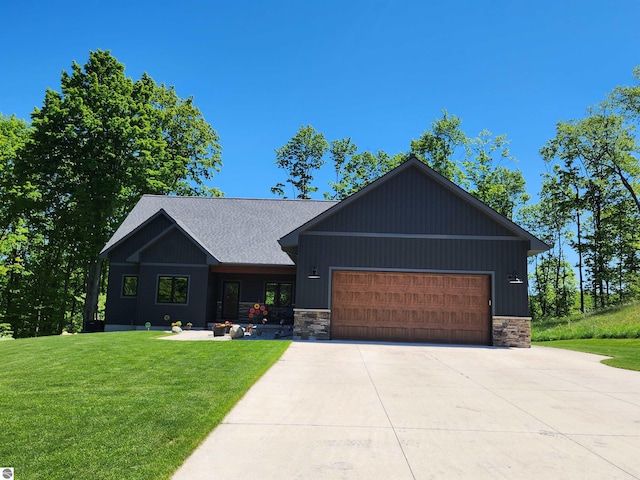 6238 E Gallivan Rd, Cedar, MI 49621 - view of front of house with stone siding, an attached garage, a front yard, and driveway