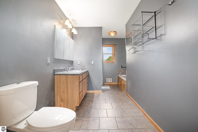 10745 W Remick Rd, Blanchard, MI 49310 - full bathroom featuring toilet, vanity, a bath, tile patterned floors, and baseboards