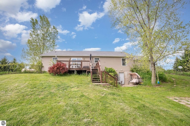 10745 W Remick Rd, Blanchard, MI 49310 - back of property with stairway, a deck, and a lawn