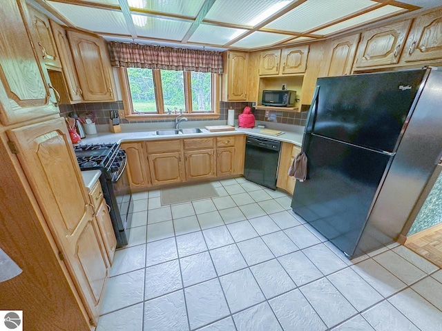 4809 N Alamando Rd, Coleman, MI 48618 - kitchen featuring black appliances, a sink, backsplash, and light countertops