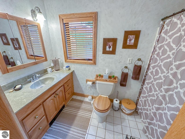 4809 N Alamando Rd, Coleman, MI 48618 - full bathroom with tile patterned floors, vanity, toilet, baseboards, and a shower with curtain