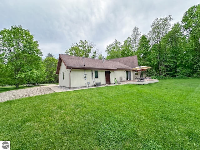 4809 N Alamando Rd, Coleman, MI 48618 - view of front of home featuring a patio area, a front yard, and central AC