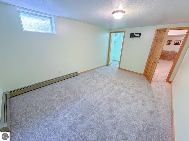 4809 N Alamando Rd, Coleman, MI 48618 - spare room with a textured ceiling, light carpet, baseboards, and baseboard heating