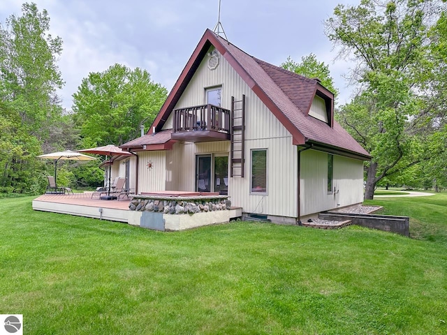 4809 N Alamando Rd, Coleman, MI 48618 - rear view of house with a balcony, roof with shingles, a lawn, and a wooden deck