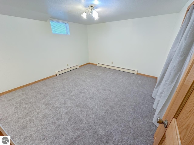 4809 N Alamando Rd, Coleman, MI 48618 - carpeted spare room featuring a baseboard radiator, baseboards, and a textured ceiling
