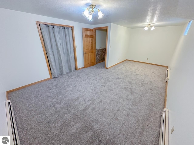4809 N Alamando Rd, Coleman, MI 48618 - carpeted empty room with baseboard heating, baseboards, and a textured ceiling