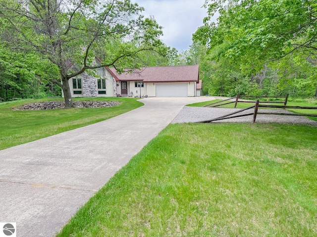 4809 N Alamando Rd, Coleman, MI 48618 - ranch-style house featuring an attached garage, driveway, a front lawn, and stone siding
