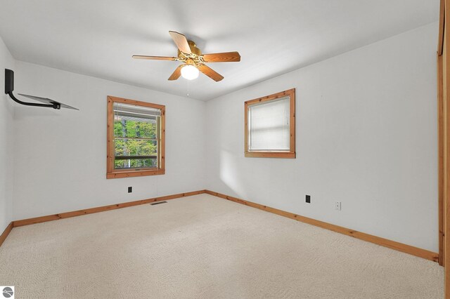 2460 E 26th Rd, Cadillac, MI 49601 - empty room with ceiling fan, baseboards, and carpet