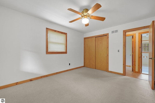 2460 E 26th Rd, Cadillac, MI 49601 - unfurnished bedroom featuring baseboards, light colored carpet, a closet, and ceiling fan