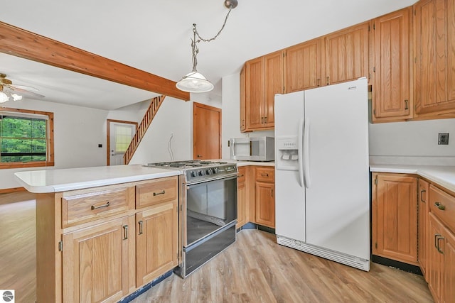 2460 E 26th Rd, Cadillac, MI 49601 - kitchen featuring white refrigerator with ice dispenser, range with gas stovetop, stainless steel microwave, a peninsula, and light wood finished floors