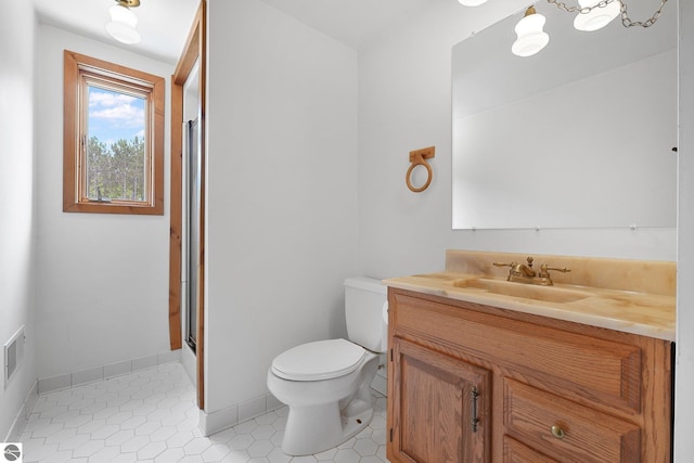 2460 E 26th Rd, Cadillac, MI 49601 - bathroom with toilet, vanity, a shower with shower door, tile patterned flooring, and baseboards