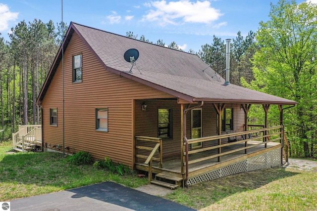 2460 E 26th Rd, Cadillac, MI 49601 - view of side of home with a shingled roof and a lawn