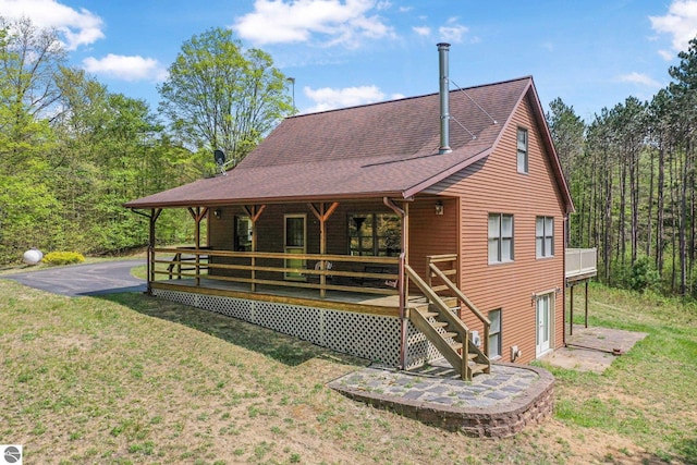 2460 E 26th Rd, Cadillac, MI 49601 - rear view of house featuring a yard and a shingled roof