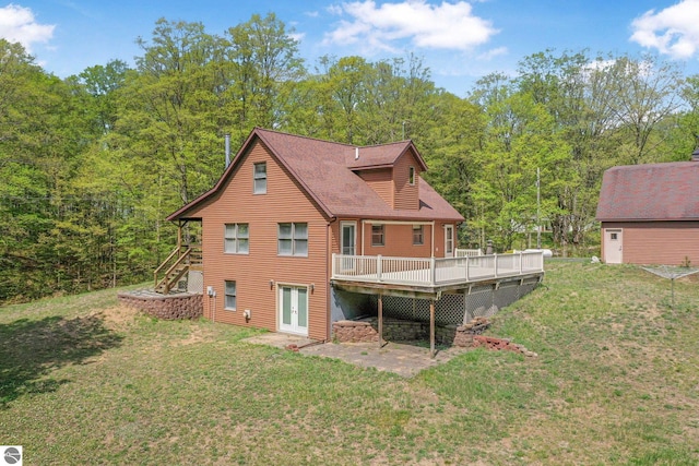 2460 E 26th Rd, Cadillac, MI 49601 - rear view of house featuring stairway, french doors, a deck, and a lawn