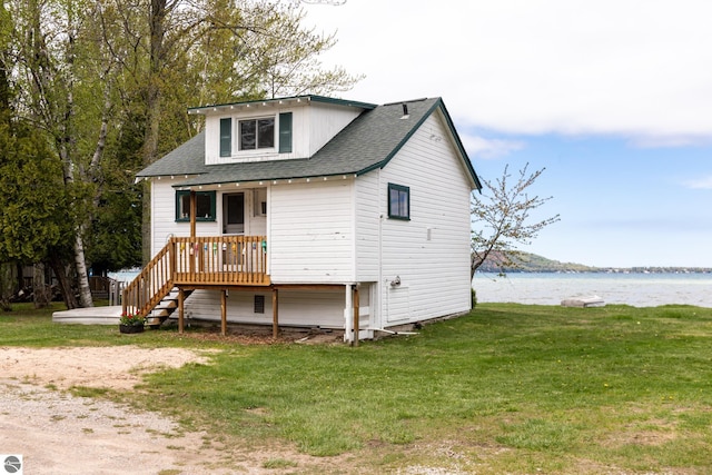 5434 W Macfarlane Rd, Glen Arbor, MI 49636 - view of front facade with a water view, stairway, a front lawn, and a shingled roof