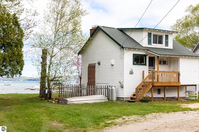 5434 W Macfarlane Rd, Glen Arbor, MI 49636 - view of front of property with a chimney, a shingled roof, and a water view