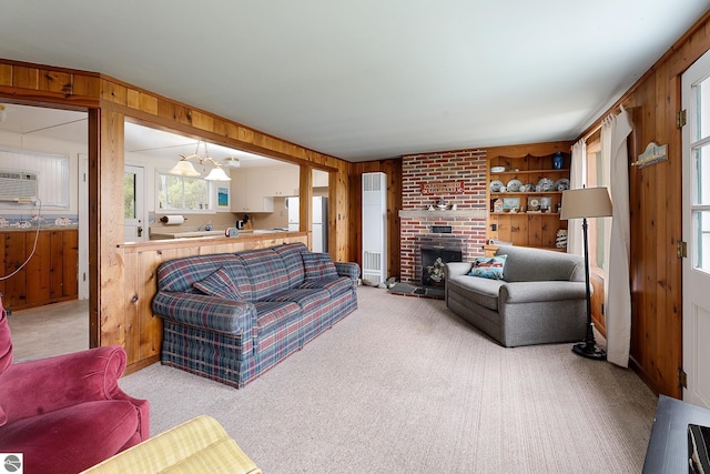 5434 W Macfarlane Rd, Glen Arbor, MI 49636 - carpeted living area featuring wood walls and a brick fireplace