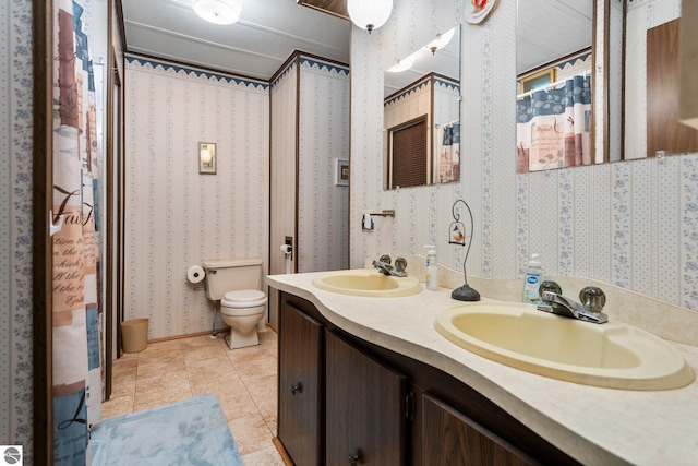 1912 Rosenburg Rd, Kalkaska, MI 49646 - bathroom with toilet, double vanity, and tile patterned flooring