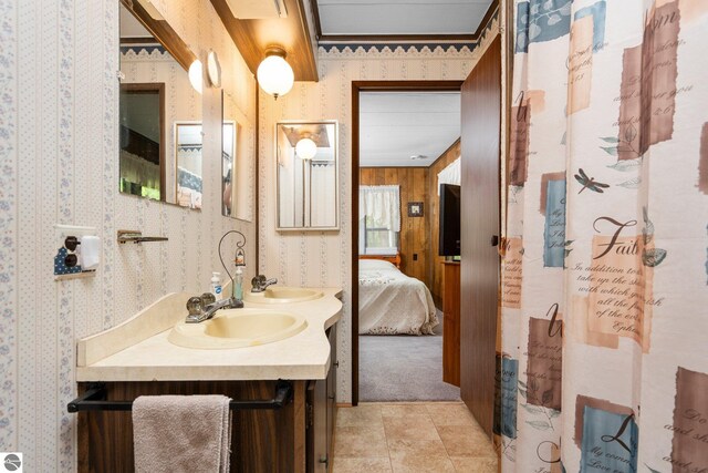 1912 Rosenburg Rd, Kalkaska, MI 49646 - full bath with wallpapered walls, double vanity, and ensuite bath