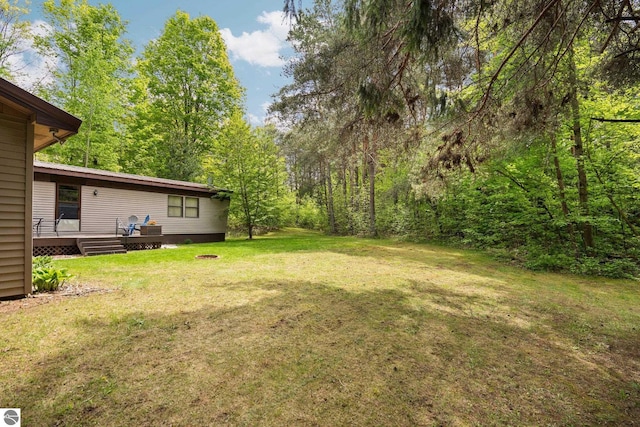1912 Rosenburg Rd, Kalkaska, MI 49646 - view of grassy yard with a deck