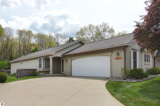 1162 Hemingway Ln, Traverse City, MI 49686 - ranch-style home with driveway, an attached garage, and a shingled roof