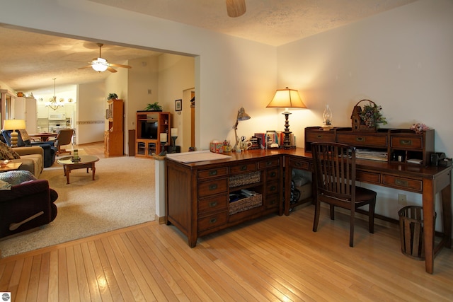 1162 Hemingway Ln, Traverse City, MI 49686 - office space featuring a ceiling fan, a chandelier, light wood-style flooring, and a textured ceiling