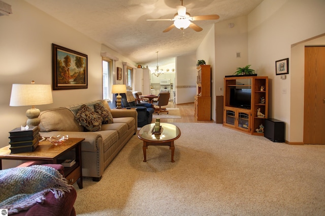 1162 Hemingway Ln, Traverse City, MI 49686 - living area featuring a chandelier, vaulted ceiling, a ceiling fan, a textured ceiling, and carpet floors