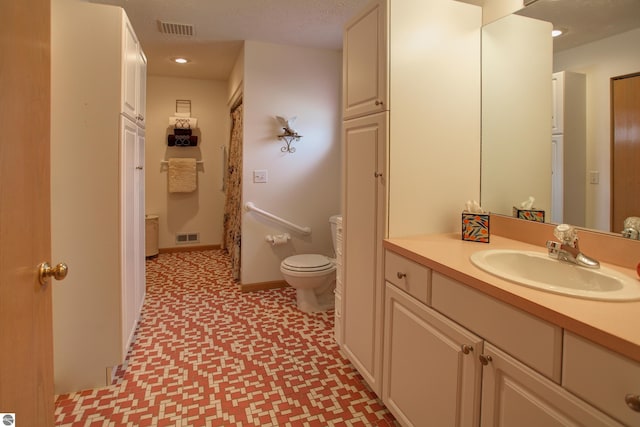 1162 Hemingway Ln, Traverse City, MI 49686 - full bathroom with tile patterned floors, toilet, vanity, and recessed lighting