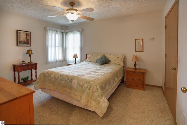 1162 Hemingway Ln, Traverse City, MI 49686 - bedroom with light carpet, a textured ceiling, a ceiling fan, and baseboards