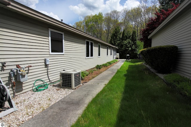 1162 Hemingway Ln, Traverse City, MI 49686 - view of grassy yard with central AC