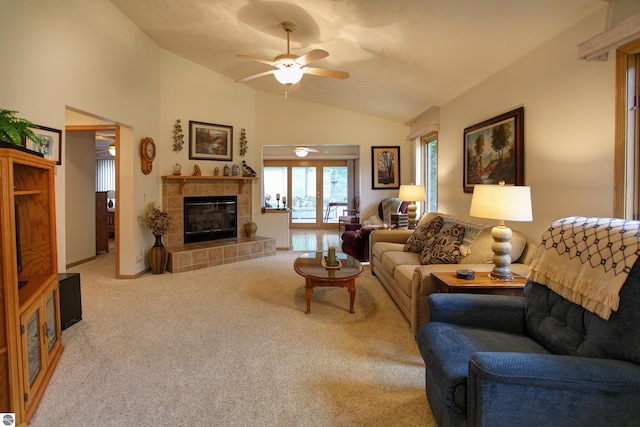 1162 Hemingway Ln, Traverse City, MI 49686 - carpeted living room featuring vaulted ceiling, ceiling fan, and a tile fireplace