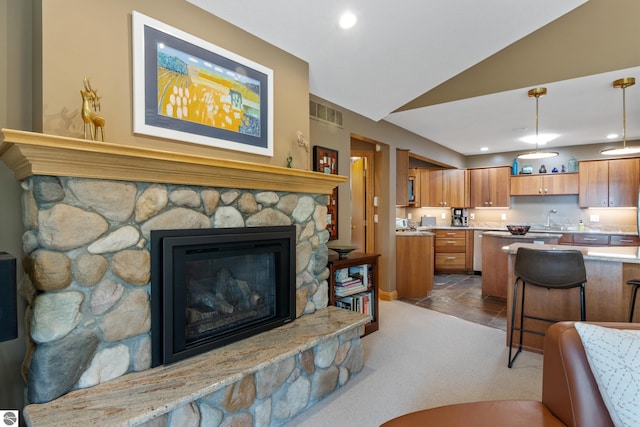 11896 Cabana Shores Rd, Williamsburg, MI 49690 - living area featuring vaulted ceiling, recessed lighting, a fireplace, and carpet