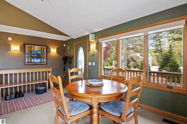 11896 Cabana Shores Rd, Williamsburg, MI 49690 - dining area with vaulted ceiling, carpet, and baseboards