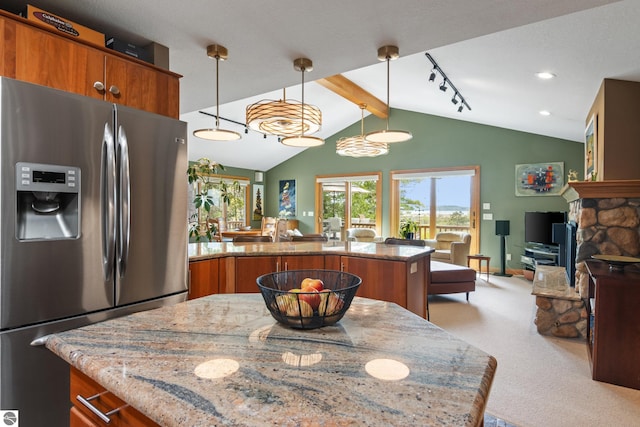 11896 Cabana Shores Rd, Williamsburg, MI 49690 - kitchen featuring stainless steel fridge, brown cabinets, light stone counters, light carpet, and a peninsula