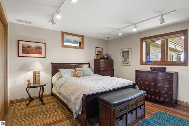 11896 Cabana Shores Rd, Williamsburg, MI 49690 - bedroom featuring track lighting, wood finished floors, and baseboards