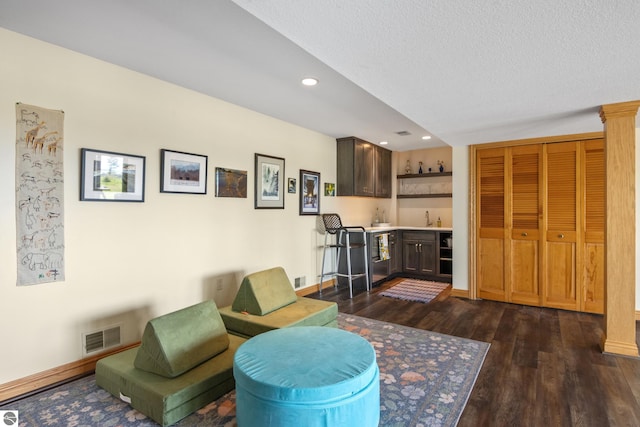 11896 Cabana Shores Rd, Williamsburg, MI 49690 - living room with bar with sink, dark wood-style floors, recessed lighting, baseboards, and a textured ceiling