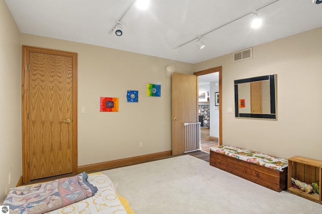 11896 Cabana Shores Rd, Williamsburg, MI 49690 - carpeted bedroom featuring track lighting and baseboards
