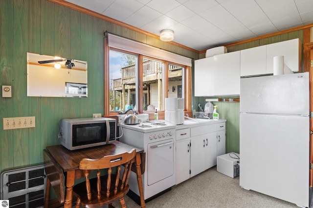 11896 Cabana Shores Rd, Williamsburg, MI 49690 - kitchen with freestanding refrigerator, stainless steel microwave, stove, white cabinetry, and light countertops