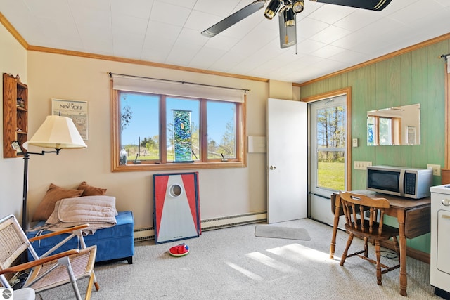 11896 Cabana Shores Rd, Williamsburg, MI 49690 - carpeted home office with ornamental molding, baseboard heating, a ceiling fan, wood walls, and baseboards